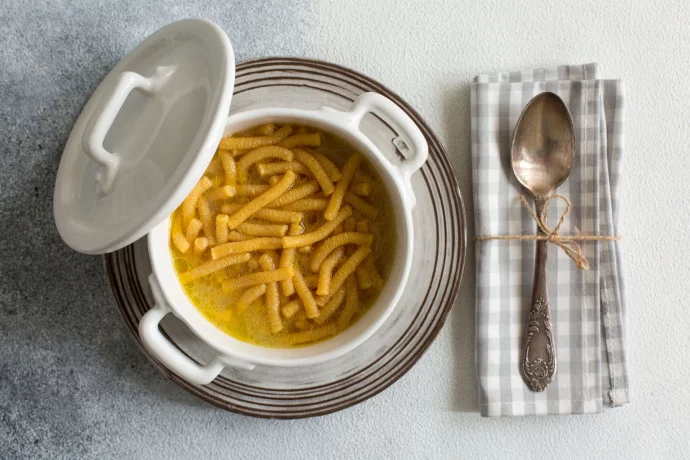 PASSATELLI IN BRODO in a plate on a table